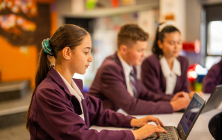 A photo of three St Anthony of Padua Austral students learning and on their way to 2026 NAPLAN success